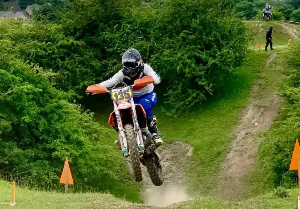 Enduro Bike Jumping off a hill climb at a Tbec Race